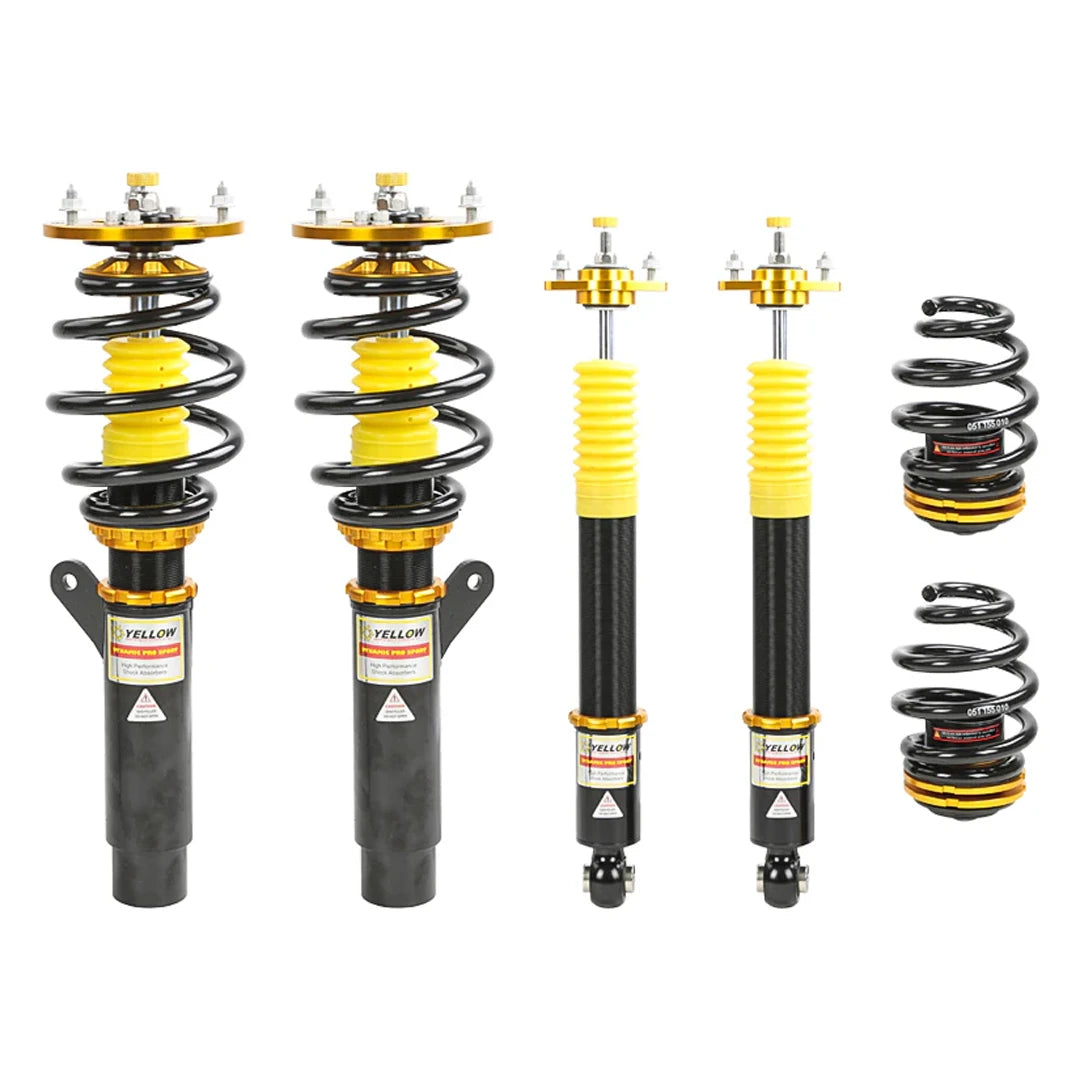 Set of four yellow speed racing coilovers on a white background