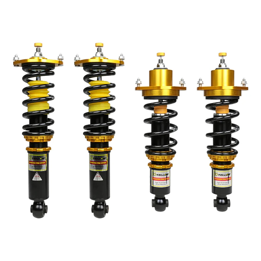 Set of four yellow speed racing coilovers on a white background
