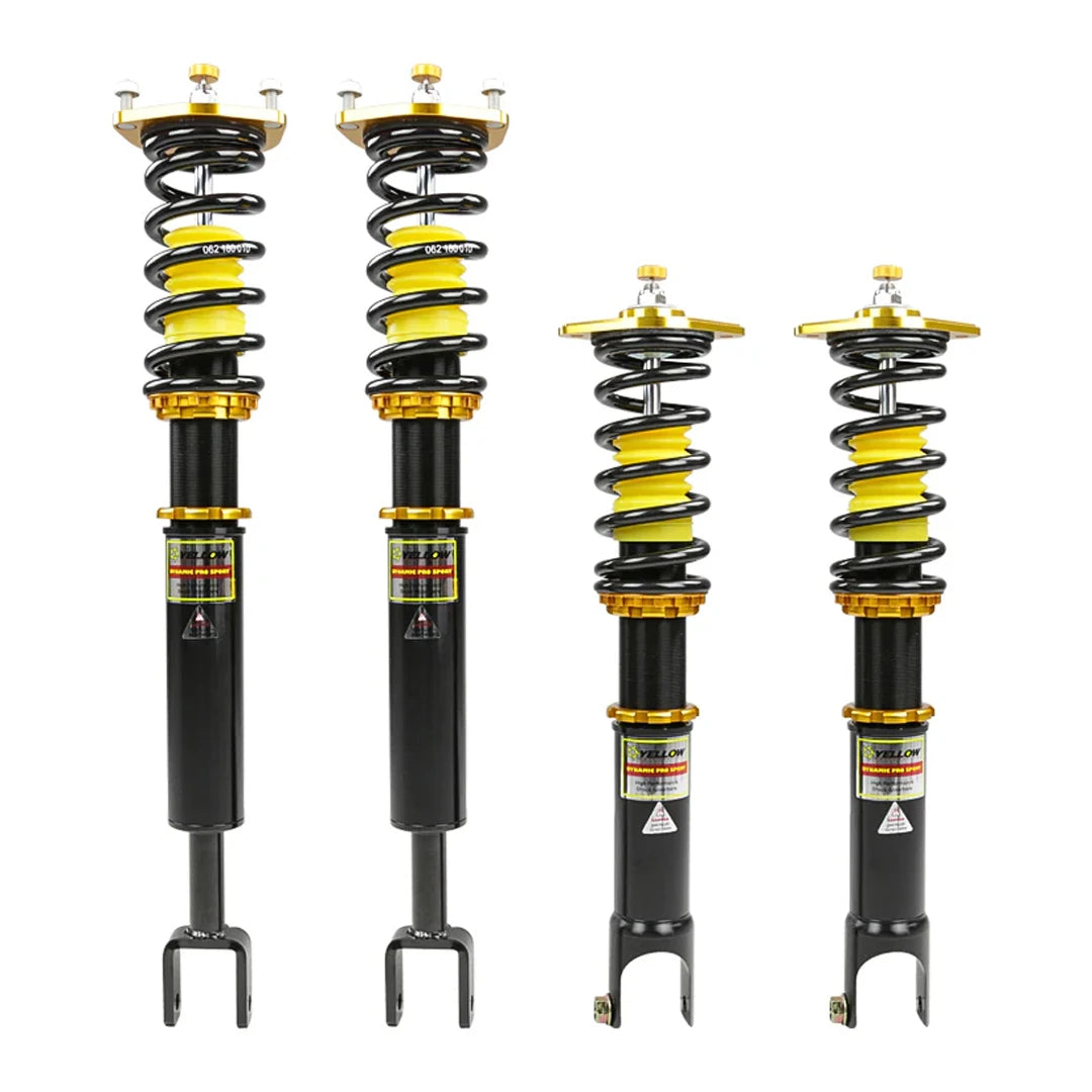 Set of four yellow speed racing coilovers on a white background