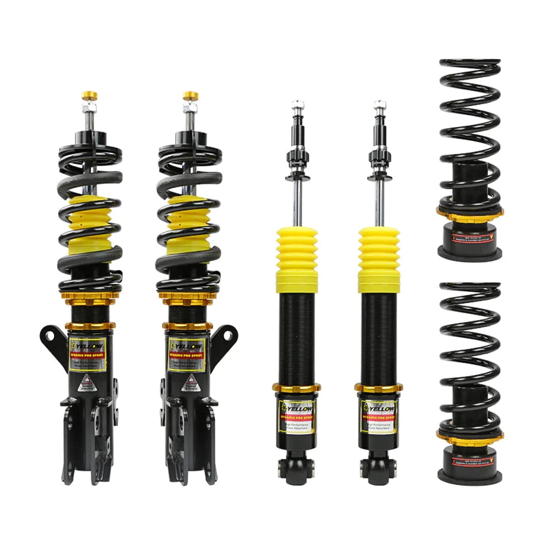 Set of four yellow speed racing coilovers on a white background