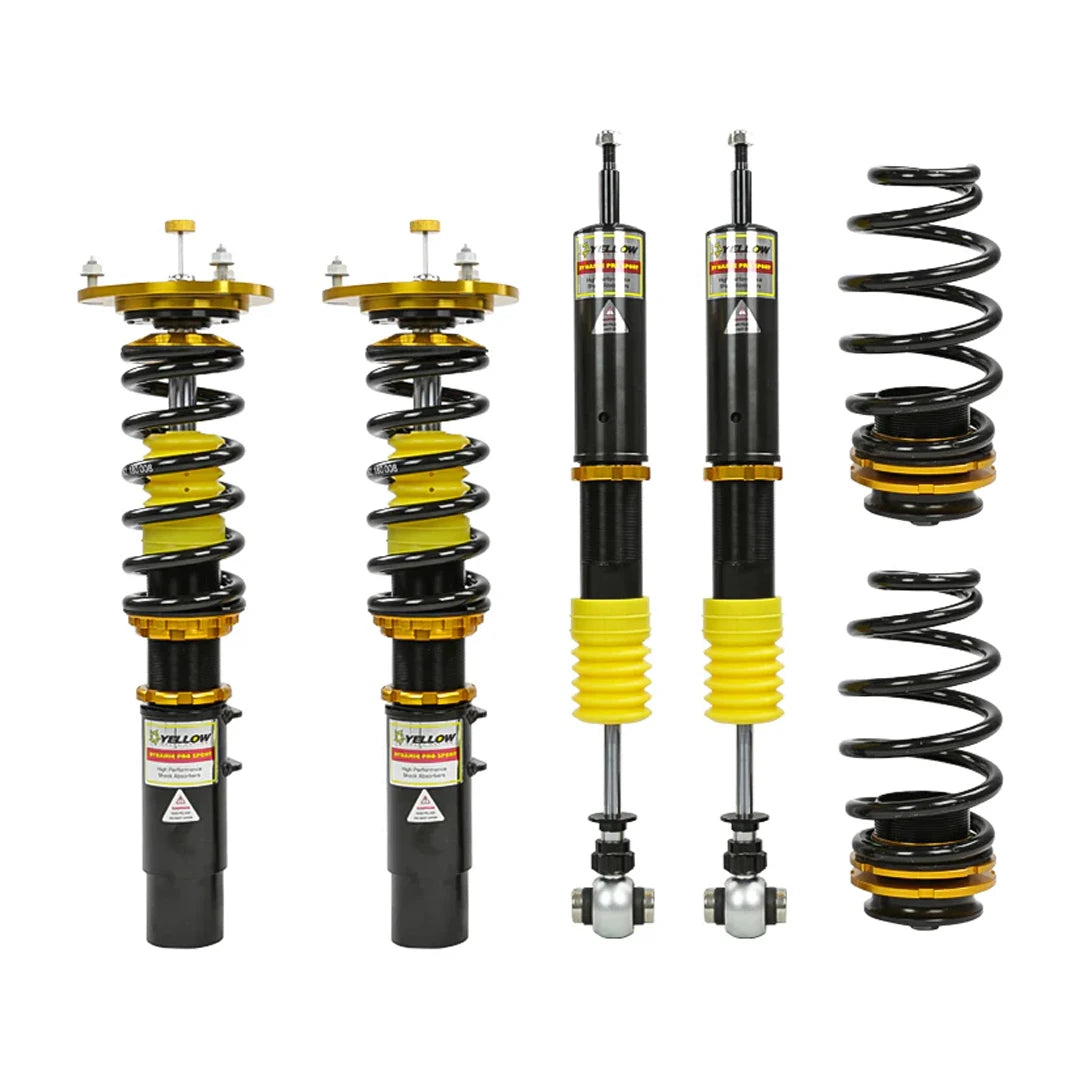 Set of four yellow speed racing coilovers on a white background