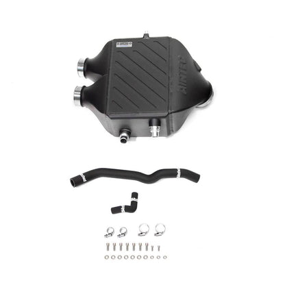 Black automotive chargecooler parts including a large component and hoses on a white background