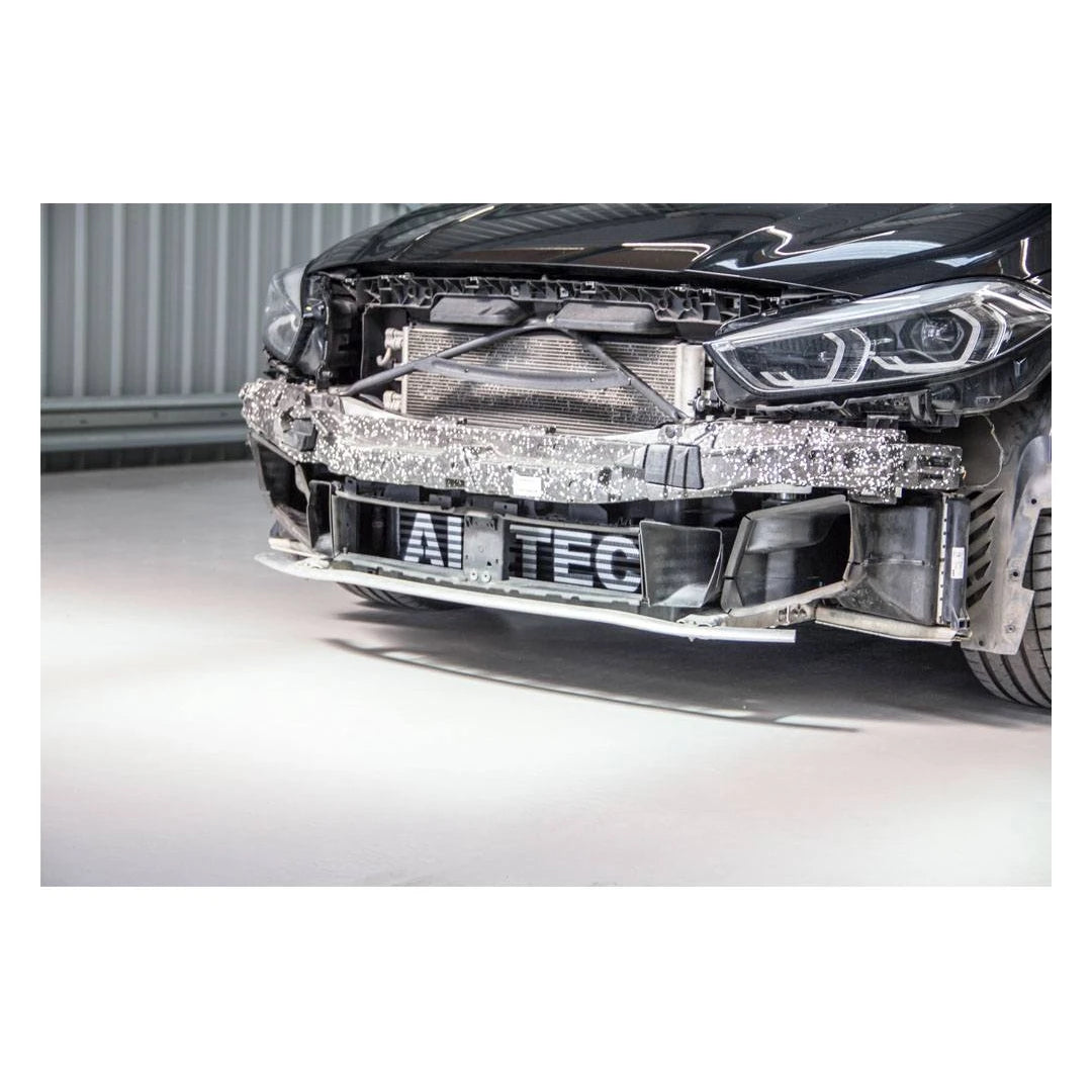 Close-up of a car's front bumper with visible branding on a white background