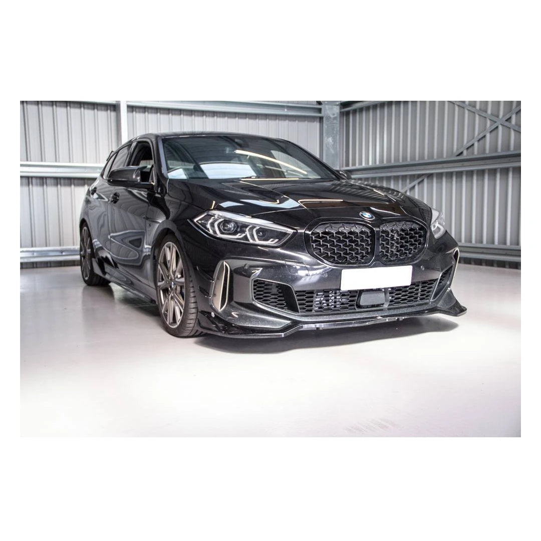 Black BMW car on a white floor with a metallic wall background