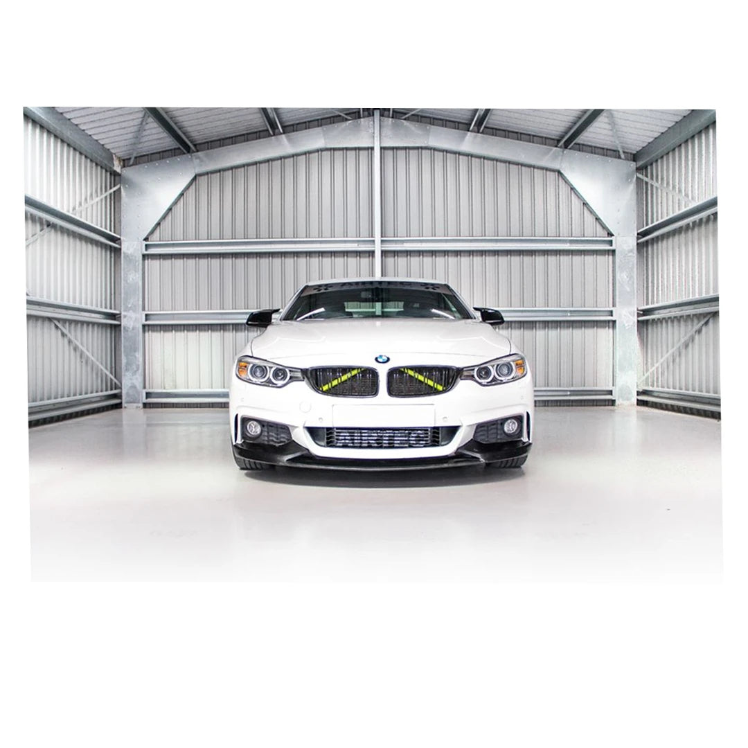 White BMW car in a large, white warehouse.
