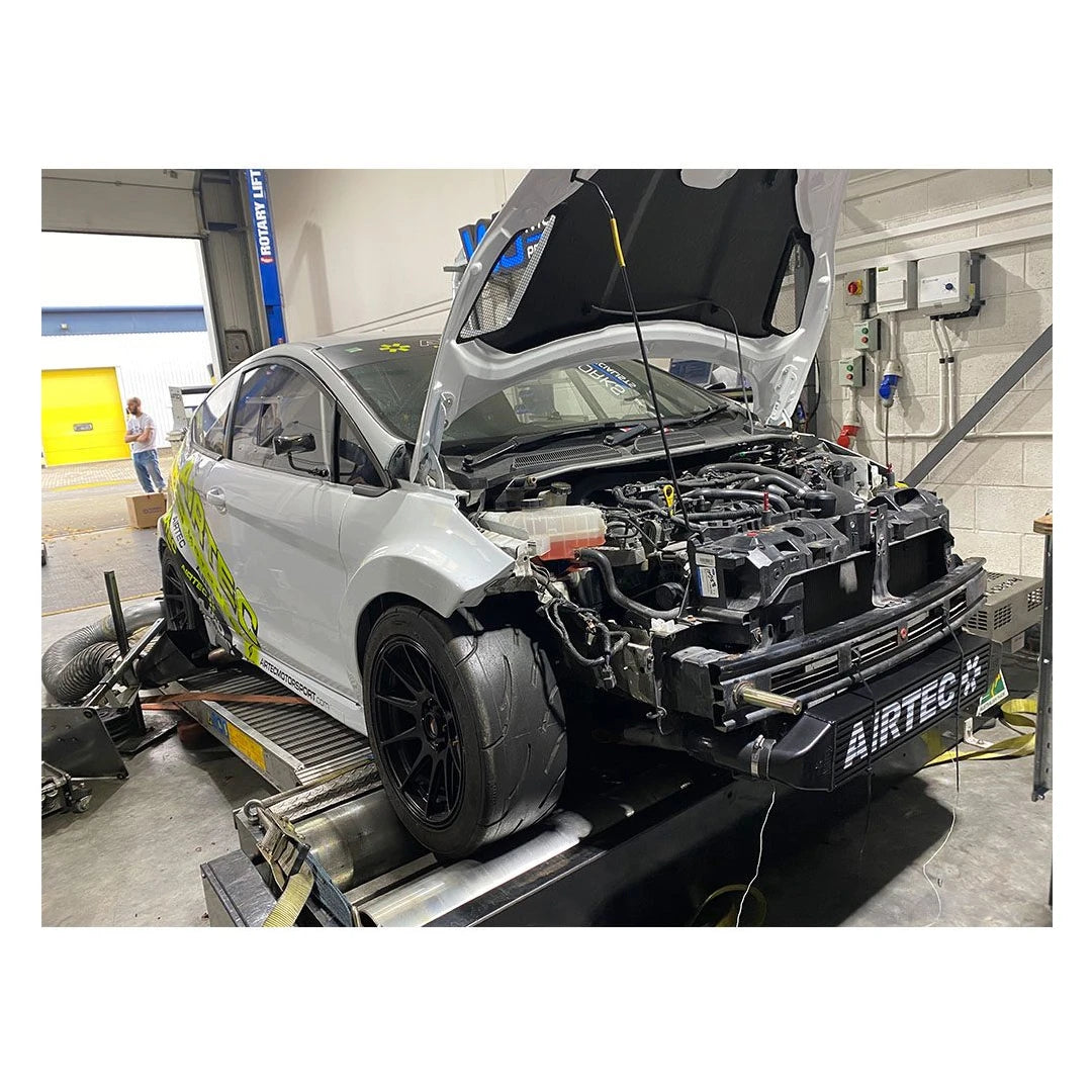 Car on a lift in a garage with 'Airtec' branding