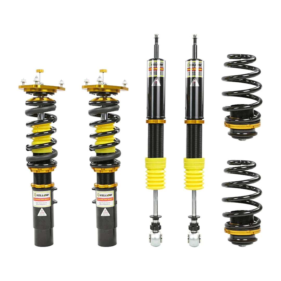Set of four yellow speed racing coilovers on a white background