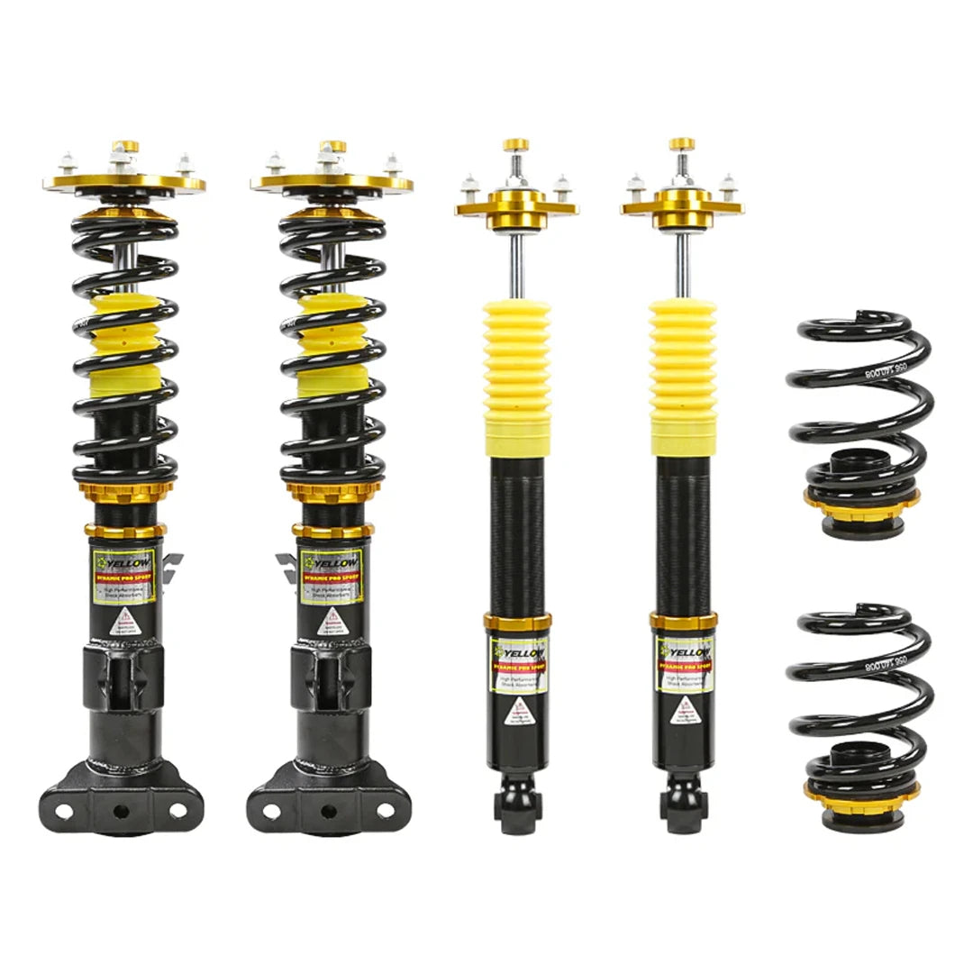 Set of four yellow speed racing coilovers on a white background