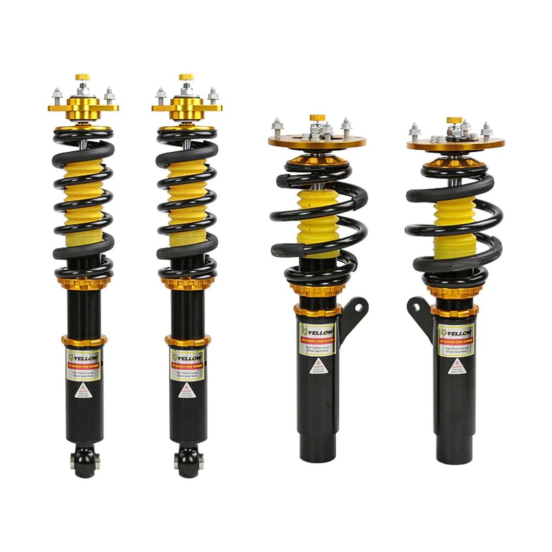 Set of four yellow speed racing coilovers on a white background