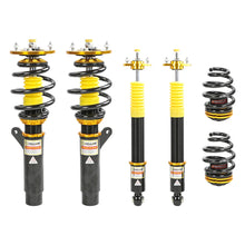 Set of four yellow speed racing coilovers on a white background