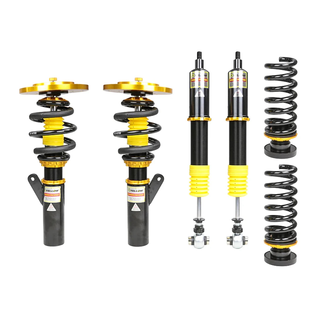 Set of four yellow speed racing coilovers on a white background
