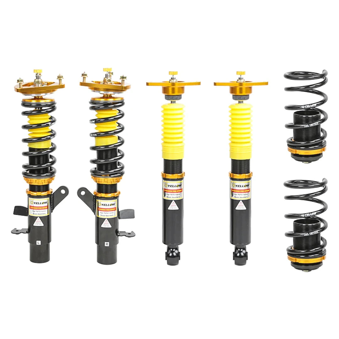 Set of four yellow speed racing coilovers on a white background