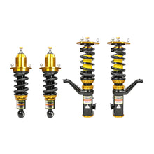 Set of four yellow speed racing coilovers on a white background