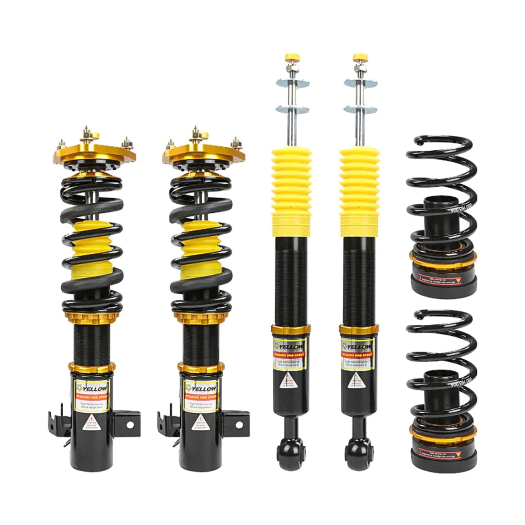 Set of four yellow speed racing coilovers on a white background
