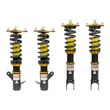Set of four yellow speed racing coilovers on a white background