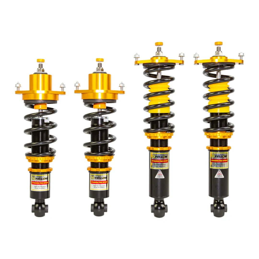 Set of four yellow speed racing coilovers on a white background