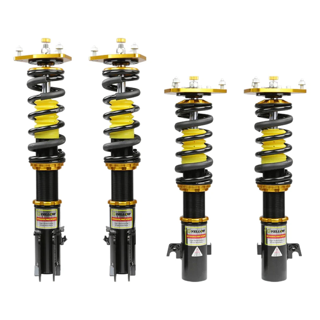 Set of four yellow speed racing coilovers on a white background