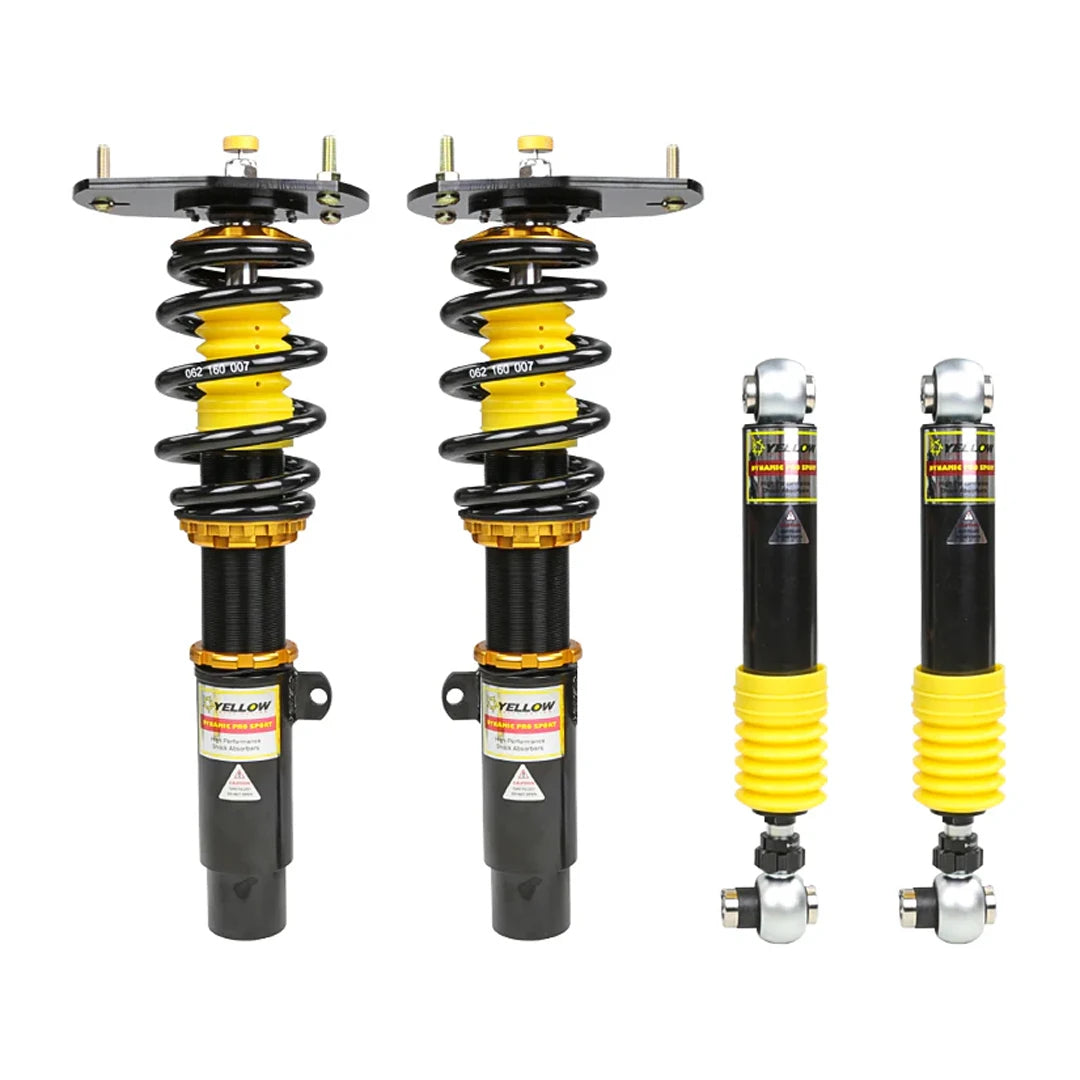 Set of four yellow speed racing coilovers on a white background
