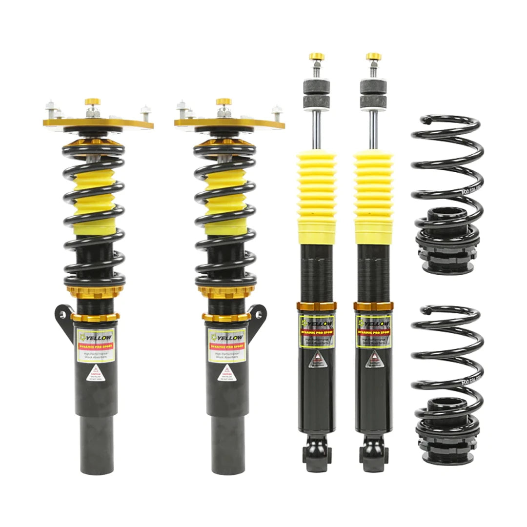 Set of four yellow speed racing coilovers on a white background