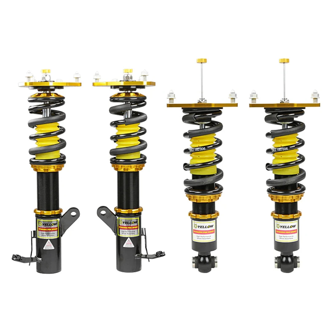 Set of four yellow speed racing coilovers on a white background