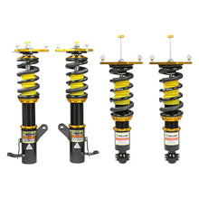 Set of four yellow speed racing coilovers on a white background