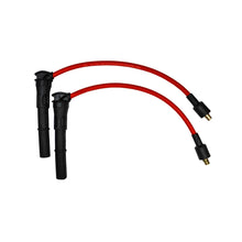 Two ignition cables with red wires and black connectors on a white background